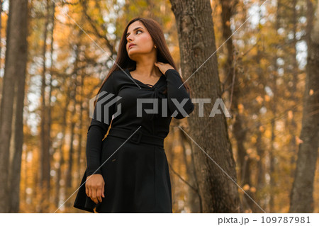 Close up portrait of pretty indian young woman enjoying warm autumn sunny day vacation outdoors copy space mockup. Generation z and gen z concept. Fall Season 109787981