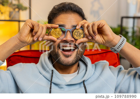 Indian man stock trader earning bitcoins online monitoring trading operations mining hold BTC coins Indian man stock trader earning bitcoins online monitoring trading operations mining hold BTC coins 109788990
