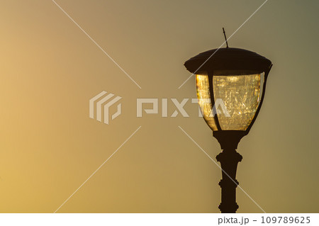 Street lamp on sunset background. Concept of design of the parks and walking streets. Maintenance of them. 109789625