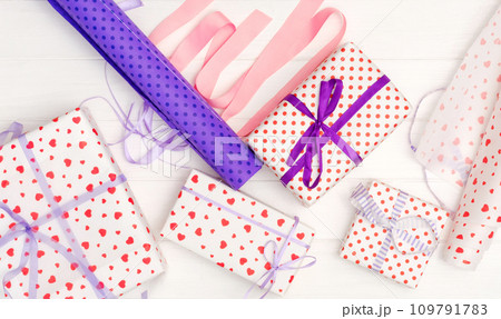 Girl tied ribbon on the gift Girl tied ribbon on the gift 109791783