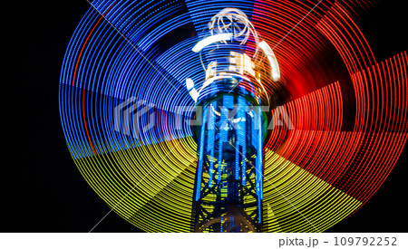 Neon lights of spinning carousel with dark sky background 109792252