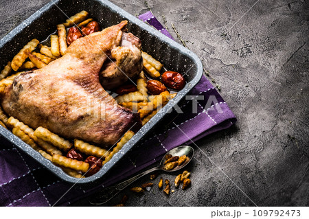 Turkey wing with french fries in baking tray top view Turkey wing with french fries in baking tray top view 109792473