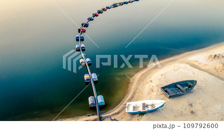 Aerial view of blue tube with barrels on the lake 109792600