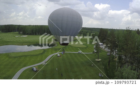 Big air balloon in white color with basket. Aerial on the big balloon Big air balloon in white color with basket. Aerial on the big balloon 109793721