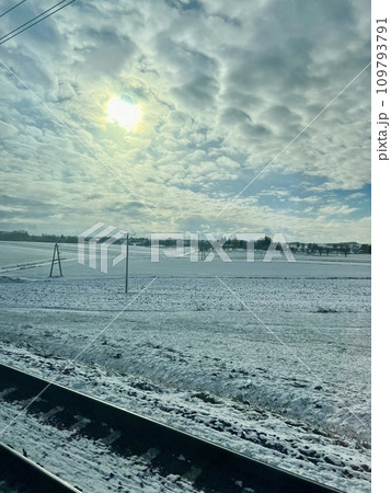 Beautiful winter landscape with snow-covered fields and blue sky. Railway tracks in the snow. Winter landscape with snow and blue sky 109793791