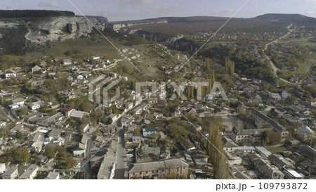 Aerial view of the city, houses and roads with trees. Shot. Urban landscape Aerial view of the city, houses and roads with trees. Shot. Urban landscape 109793872