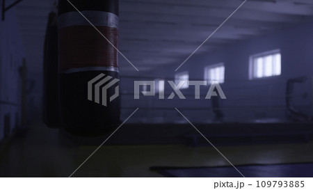 Interior of a fitness hall with a punching bag. Punching bag in the hall Interior of a fitness hall with a punching bag. Punching bag in the hall 109793885