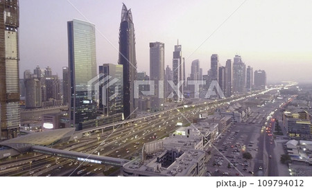 Modern buildings and highway. View on modern skyscrapers and busy evening highways day in luxury downtown of Dubai city. Top aerial view from tower rooftop. Road junction traffic. Beautiful daytime 109794012