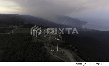 Bay of the sea, mountains, rocks, embankment and city buildings at the sunset aerial view. Shot. Aerial of sunset. Aerial shot of amazing mountains and rocks on a seashore Bay of the sea, mountains, rocks, embankment and city buildings at the sunset aerial view. Shot. Aerial of sunset. Aerial shot of amazing mountains and rocks on a seashore 109794180