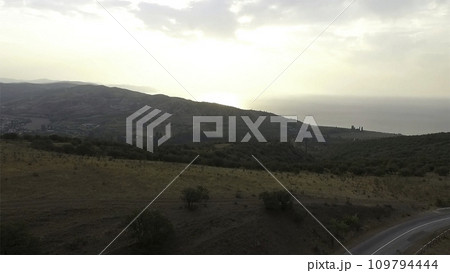 Aerial View. Shot. Flying over the high mountains in beautiful clouds Aerial View. Shot. Flying over the high mountains in beautiful clouds 109794444