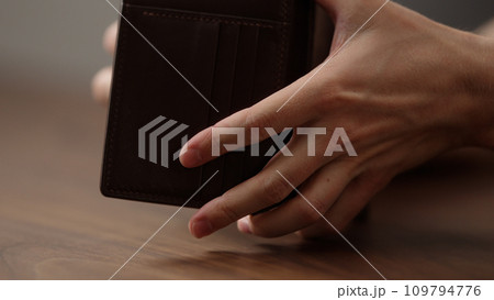 man check leather wallet on wood table man check leather wallet on wood table 109794776