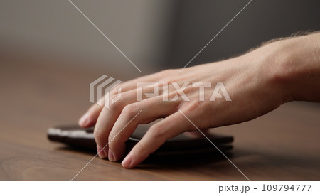 closeup man take leather wallet from wood table closeup man take leather wallet from wood table 109794777