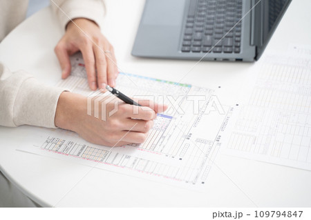 確定申告書類を準備する男性の手元 確定申告書類を準備する男性の手元 109794847