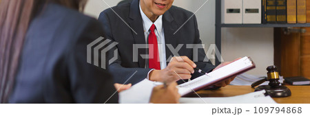 Legal and justice concept, Senior lawyer pointing on contract and discussing with female lawyer Legal and justice concept, Senior lawyer pointing on contract and discussing with female lawyer 109794868