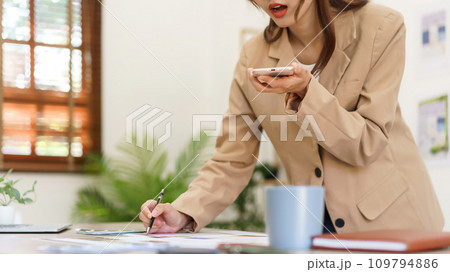 Architectural concept, Female architect talks with client on smartphone about house interior design Architectural concept, Female architect talks with client on smartphone about house interior design 109794886