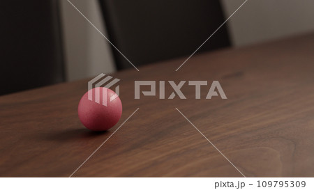 spinning easter egg on walnut table 109795309