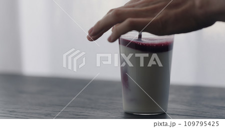 mix natural berry juice in organic yogurt in tumbler glass on black wood table with copy space mix natural berry juice in organic yogurt in tumbler glass on black wood table with copy space 109795425