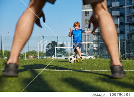 Father and son organizing family football summer camp at city stadium 109796202