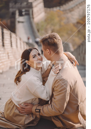 beautiful young couple showing affection on the Great Wall of China. Newly married couple on their honemoon to Great Wall near Beijing China. Stylish couple exploring one of the wonders of the world beautiful young couple showing affection on the Great Wall of China. Newly married couple on their honemoon to Great Wall near Beijing China. Stylish couple exploring one of the wonders of the world 109797176