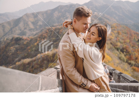 beautiful young couple showing affection on the Great Wall of China. Newly married couple on their honemoon to Great Wall near Beijing China. Stylish couple exploring one of the wonders of the world beautiful young couple showing affection on the Great Wall of China. Newly married couple on their honemoon to Great Wall near Beijing China. Stylish couple exploring one of the wonders of the world 109797178