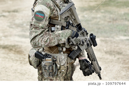 Soldier with machine gun and flag of Azerbaijan on military uniform. Collage. 109797644