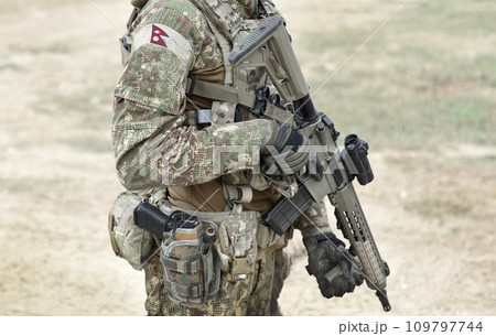 Soldier with assault rifle and flag of Nepal on military uniform. Collage. 109797744