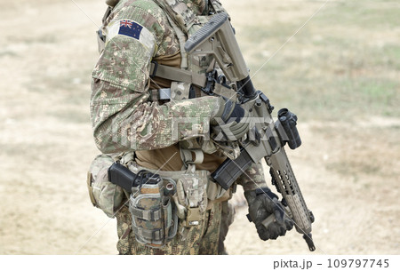 Soldier with assault rifle and flag of New Zealand on military uniform. Collage. 109797745