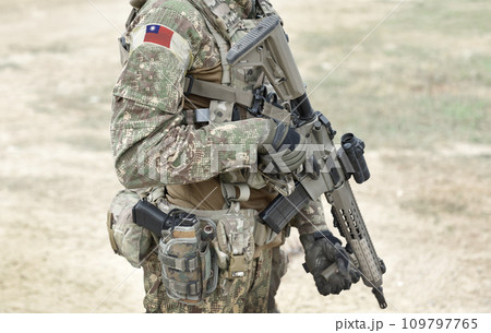Soldier with assault rifle and flag of Taiwan on military uniform. Collage. 109797765