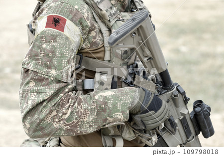 Soldier with assault rifle and flag of Albania on military uniform. Collage. Soldier with assault rifle and flag of Albania on military uniform. Collage. 109798018