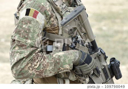 Soldier with assault rifle and flag of Belgium on military uniform. Collage. Soldier with assault rifle and flag of Belgium on military uniform. Collage. 109798049