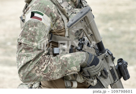 Soldier with assault rifle and flag of Kuwait on military uniform. Collage. Soldier with assault rifle and flag of Kuwait on military uniform. Collage. 109798601