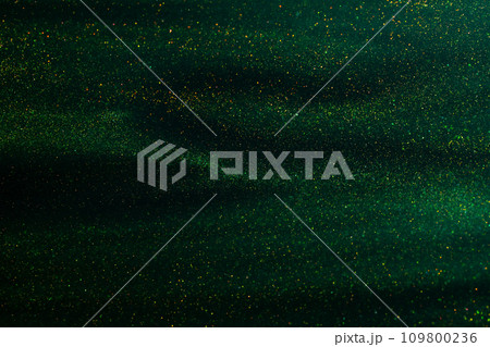 Glittering flows of gold particles in green fluid. Glittering flows of gold particles in green fluid. 109800236