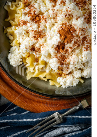 Pasta with cottage cheese, cinnamon and sugar. 109800254