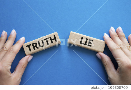 Truth or Lie symbol. Concept word Truth or Lie on wooden blocks. Businessman hand. Beautiful blue background. Business and Truth or Lie concept. Copy space 109800709