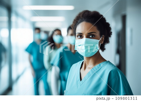 female medical workers with surgical masks in front of a hallway female medical workers with surgical masks in front of a hallway 109801311