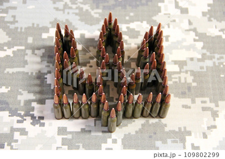 Cartridges for the Kalashnikov assault rifle. War Concept. Ukrainian symbol 109802299