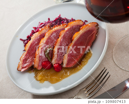 Duck breast Magret with stewed cabbage 109807413