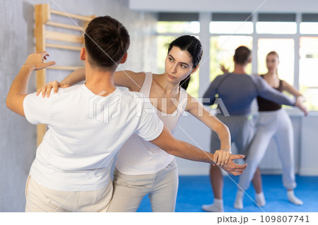 Young girl applying throwing technique on her opponent in sports hall 109807741