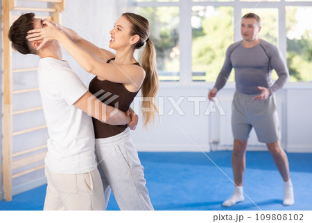 Woman delivers painful blow to eyes of an attacking man - self defense training for women and men Woman delivers painful blow to eyes of an attacking man - self defense training for women and men 109808102
