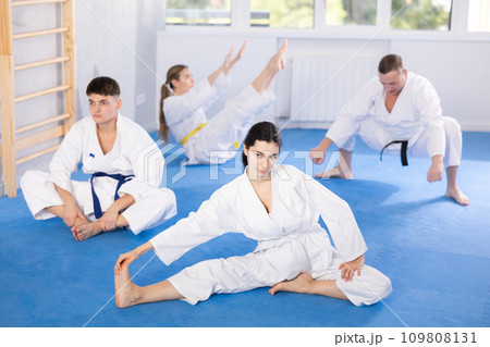 Group of people doing stretching in studio 109808131