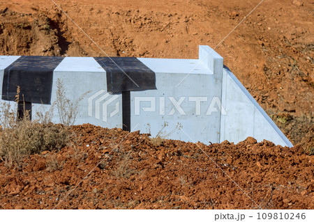 An concrete bridge constructed over stream in countryside with detailed construction 109810246