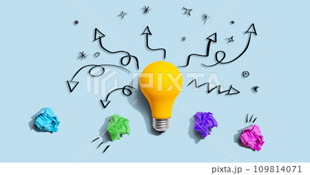 Brainstorming concept with a idea light bulb and crumpled paper 109814071