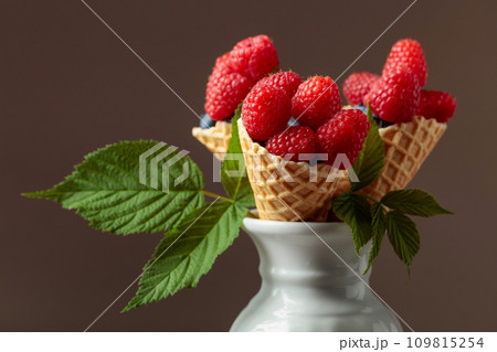 Fresh raspberries in waffle cones. 109815254