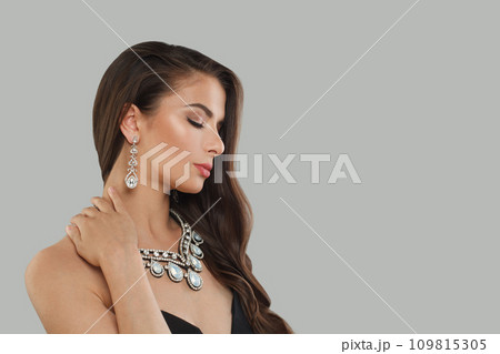 Nice jewelry woman brunette fashion model with gold diamond earning and luxury necklace posing Nice jewelry woman brunette fashion model with gold diamond earning and luxury necklace posing 109815305