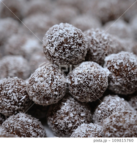 Rum balls in coconut. Traditional unbaked Czech sweets for Christmas and winter. Raw sweet food with cocoa and coconut. 109815760
