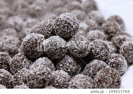 Rum balls in coconut. Traditional unbaked Czech sweets for Christmas and winter. Raw sweet food with cocoa and coconut. 109815768