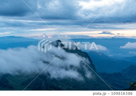 View from the top of Doi Luang Chiang Dao during a morning sunrise with moving white clouds over the beautiful mountain ranges View from the top of Doi Luang Chiang Dao during a morning sunrise with moving white clouds over the beautiful mountain ranges 109816386