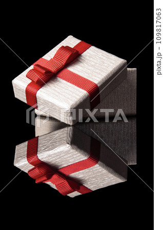 opened gift box with red ribbon isolated on black with reflection opened gift box with red ribbon isolated on black with reflection 109817063