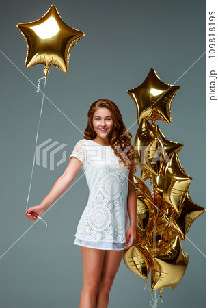 Portrait young attractive woman in white dress, holding bunch of 109818195