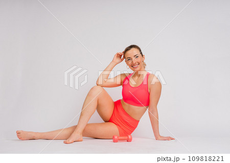 Attractive blonde caucasian smiling woman isolated on white, blue. Studio shot looking at camera 109818221